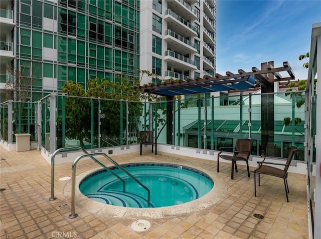 view of pool with a hot tub and a pergola