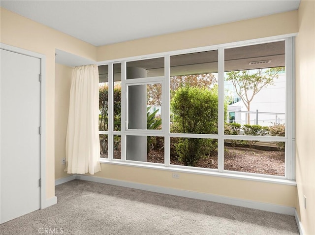 interior space featuring baseboards and carpet flooring