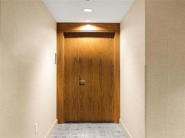 interior space featuring baseboards and recessed lighting