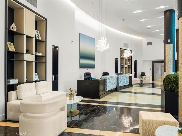 reception featuring a chandelier and visible vents