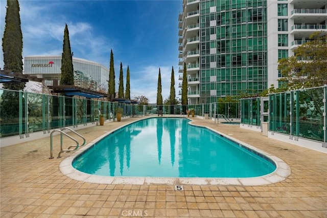 pool featuring a patio and fence