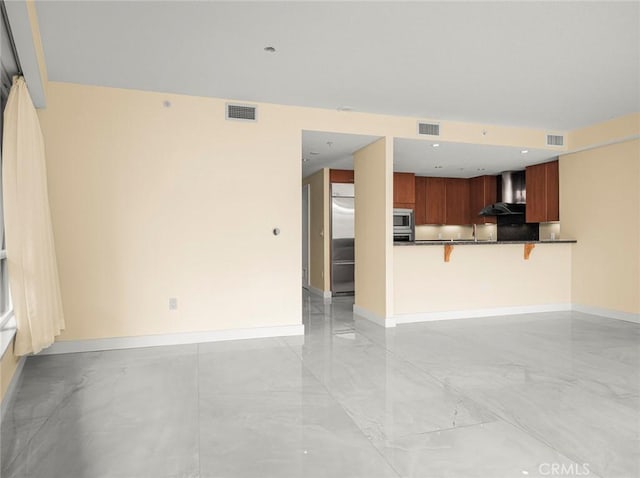 unfurnished living room with visible vents and baseboards
