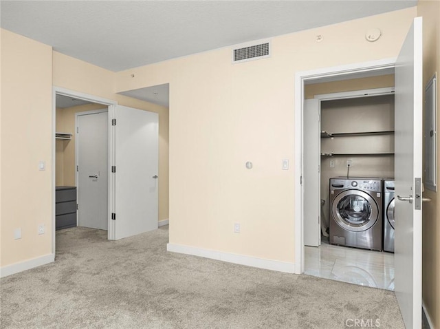 laundry room featuring laundry area, carpet floors, baseboards, visible vents, and washer and clothes dryer