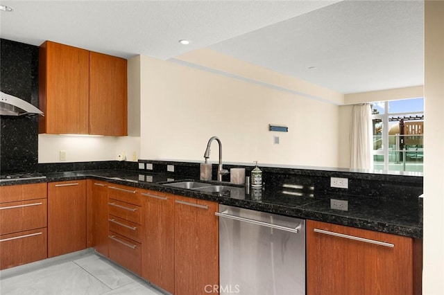 kitchen with a sink, marble finish floor, brown cabinets, and stainless steel appliances