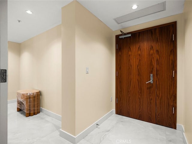 hallway featuring baseboards, recessed lighting, and visible vents