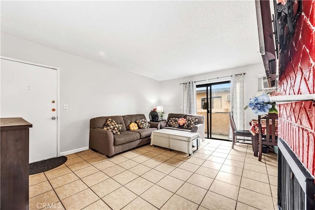 living area with baseboards, a textured ceiling, and light tile patterned flooring