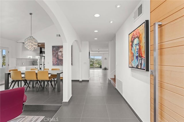303 Calle Paisano, San Clemente, CA 92673 - corridor featuring dark tile patterned floors, visible vents, recessed lighting, an inviting chandelier, and arched walkways