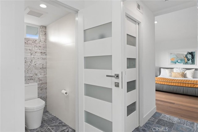 303 Calle Paisano, San Clemente, CA 92673 - bathroom with toilet, ensuite bath, tile walls, and visible vents