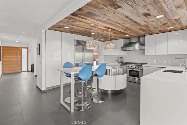 303 Calle Paisano, San Clemente, CA 92673 - kitchen with a sink, wall chimney exhaust hood, high quality appliances, white cabinets, and modern cabinets