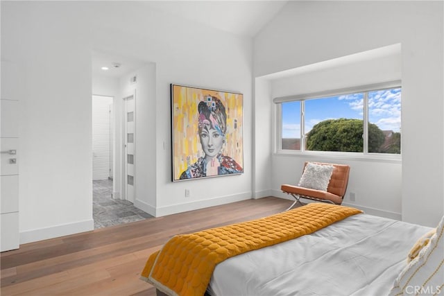 303 Calle Paisano, San Clemente, CA 92673 - bedroom featuring baseboards, vaulted ceiling, and wood finished floors