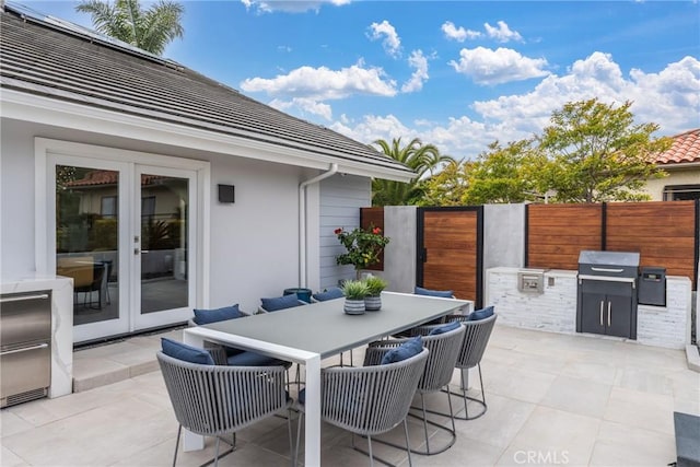 303 Calle Paisano, San Clemente, CA 92673 - view of patio / terrace featuring an outdoor kitchen, outdoor dining space, french doors, and fence