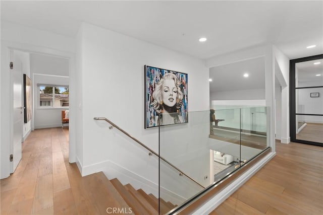 303 Calle Paisano, San Clemente, CA 92673 - corridor featuring light wood-style flooring, an upstairs landing, and recessed lighting