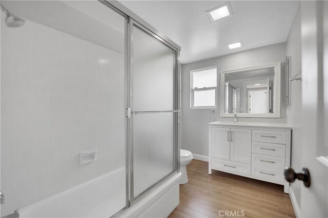24052 Estacia Ave, Laguna Niguel, CA 92677 - full bath featuring vanity, wood finished floors, toilet, baseboards, and bath / shower combo with glass door