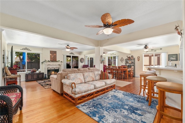 1316 Via Ln, Ranchita, San Marcos, CA 92069 - living area with light wood finished floors, ceiling fan, and a lit fireplace