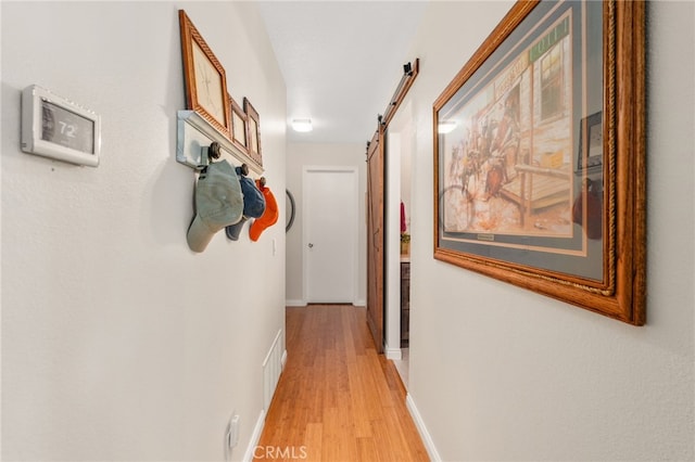 1316 Via Ln, Ranchita, San Marcos, CA 92069 - hall featuring visible vents, a barn door, light wood-style flooring, and baseboards
