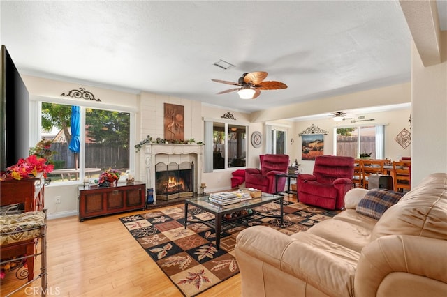 1316 Via Ln, Ranchita, San Marcos, CA 92069 - living area featuring ceiling fan, wood finished floors, and a fireplace