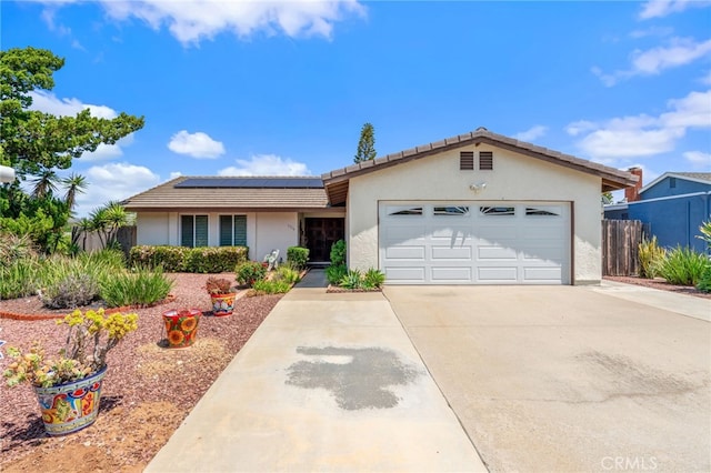 1316 Via Ln, Ranchita, San Marcos, CA 92069 - ranch-style house with an attached garage, a tile roof, stucco siding, roof mounted solar panels, and concrete driveway