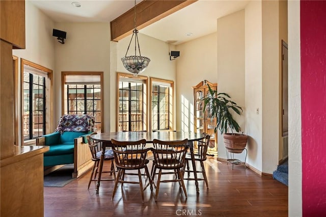 32424 Snowshoe Ln, Running Springs, CA 92382 - dining room with baseboards, dark wood-style flooring, a towering ceiling, and beamed ceiling