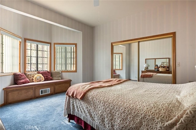 32424 Snowshoe Ln, Running Springs, CA 92382 - carpeted bedroom with wallpapered walls, visible vents, ceiling fan, and a closet