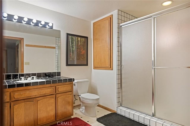 32424 Snowshoe Ln, Running Springs, CA 92382 - bathroom featuring vanity, baseboards, a stall shower, and toilet