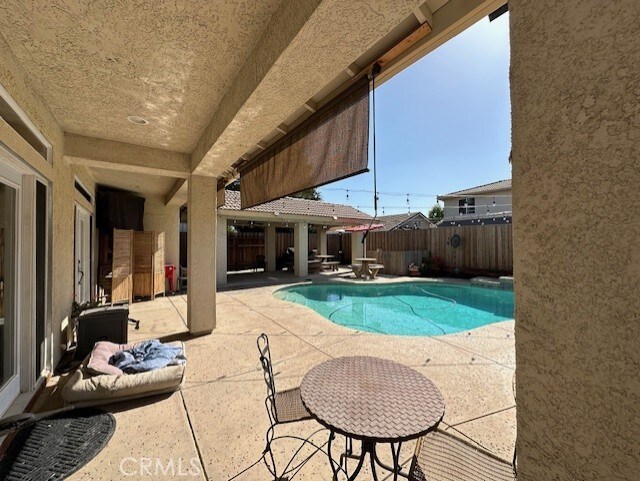 view of pool featuring a patio, a fenced in pool, and a fenced backyard