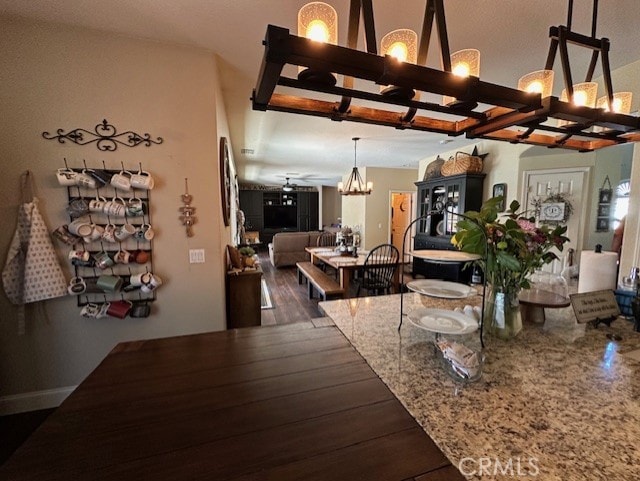 interior space with an inviting chandelier and dark wood-style flooring