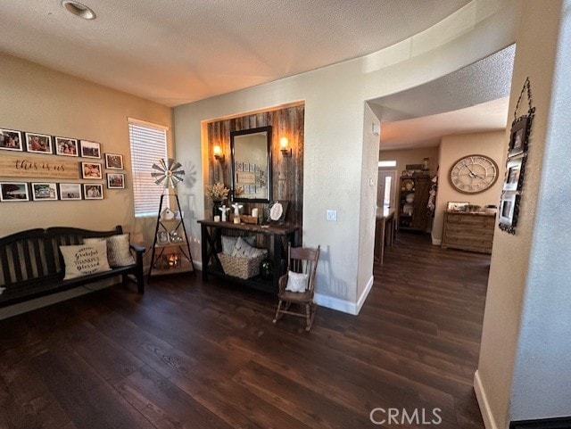 hall featuring baseboards and wood finished floors