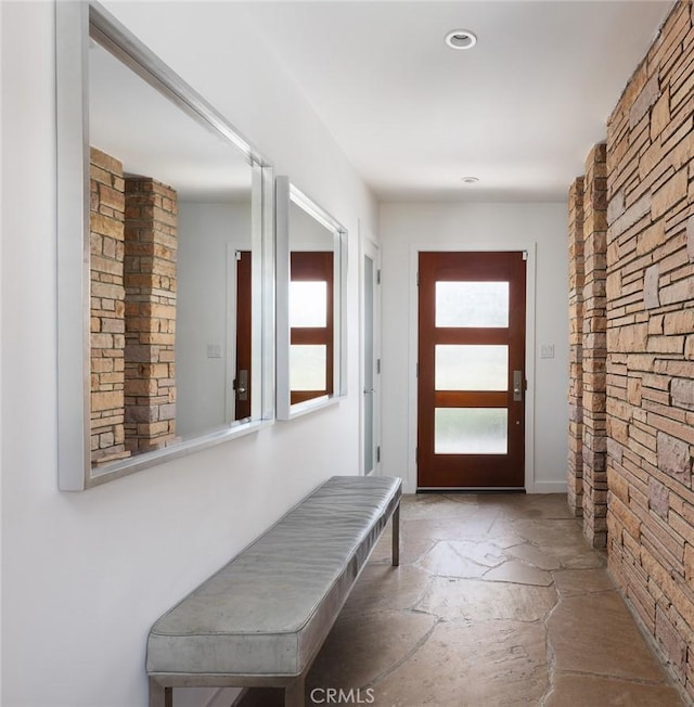 doorway to outside with stone floors