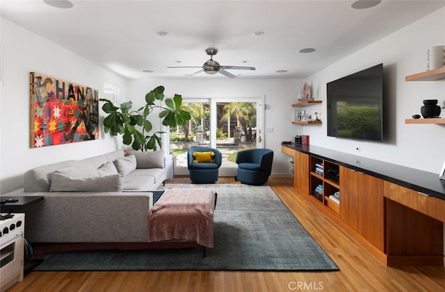 living room featuring a ceiling fan and light wood finished floors