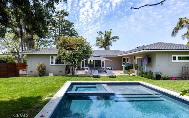 rear view of house featuring an in ground hot tub, fence, a patio, and stucco siding