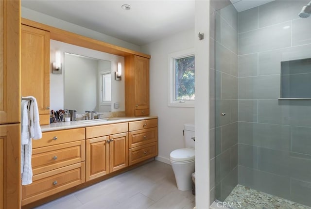bathroom with vanity, tile patterned flooring, a stall shower, and toilet