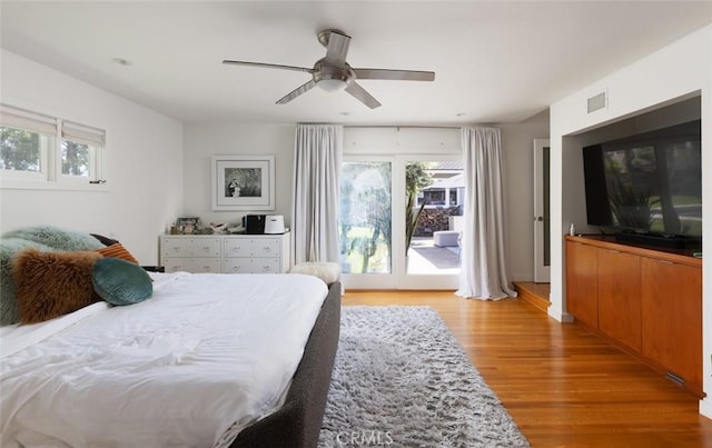 bedroom with ceiling fan, visible vents, access to exterior, and light wood finished floors
