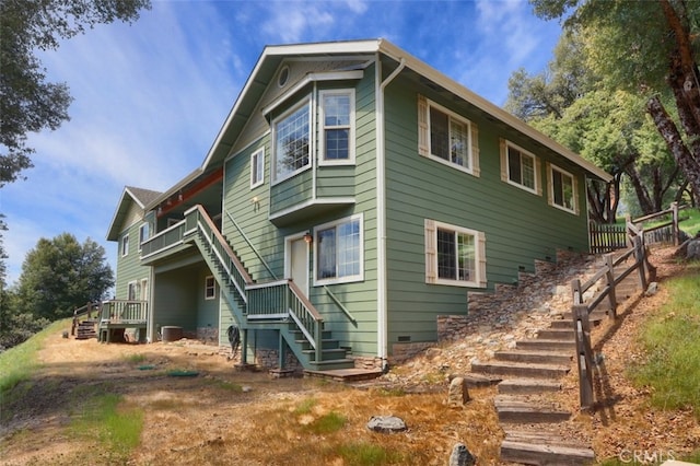 exterior space with stairs and central AC unit