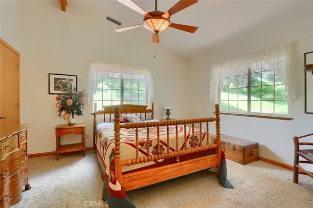 bedroom with visible vents, baseboards, carpet, and lofted ceiling