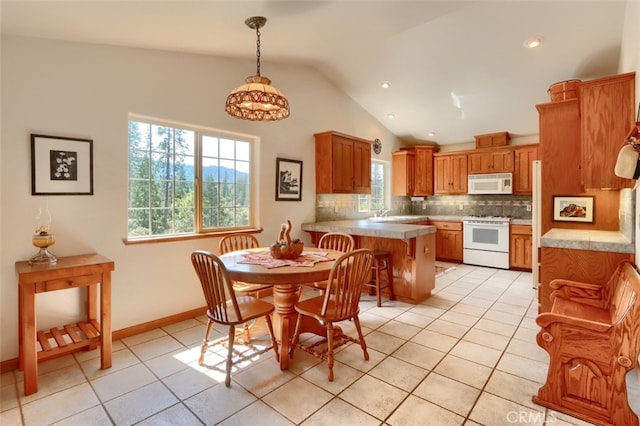dining room featuring baseboards, recessed lighting, light tile patterned floors, and lofted ceiling