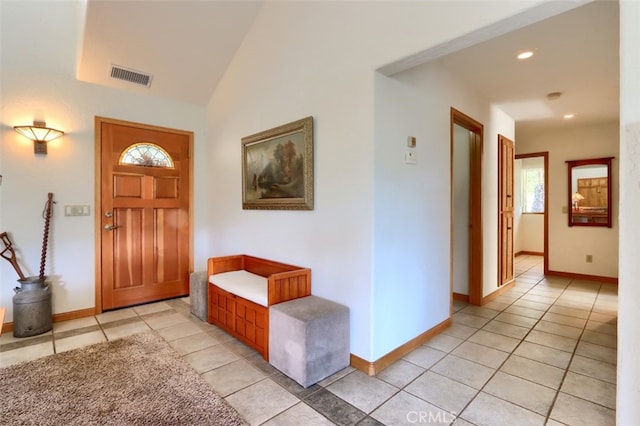 foyer featuring visible vents, baseboards, and light tile patterned floors