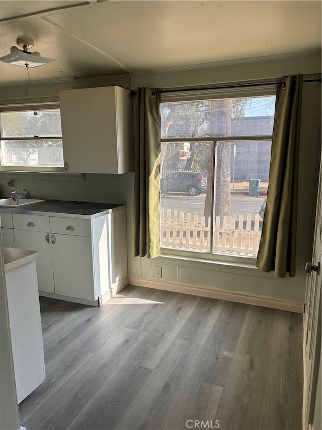 3499 Lemon St, Riverside, CA 92501 - unfurnished dining area featuring baseboards, a sink, and wood finished floors