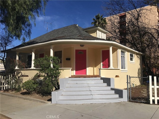 3499 Lemon St, Riverside, CA 92501 - view of front of home featuring fence, a gate, and covered porch