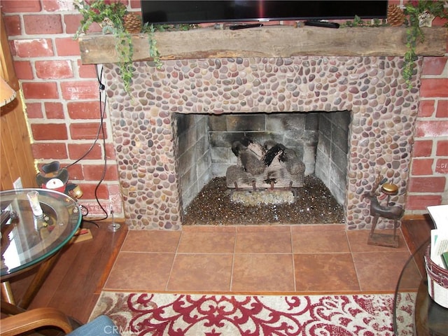 interior details with a brick fireplace