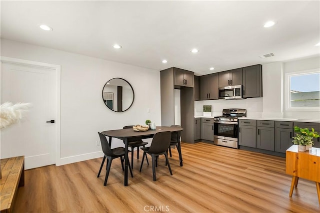 dining area featuring recessed lighting, baseboards, visible vents, and light wood-style flooring