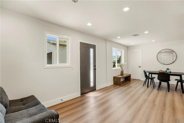 foyer with recessed lighting, light wood finished floors, baseboards, and visible vents