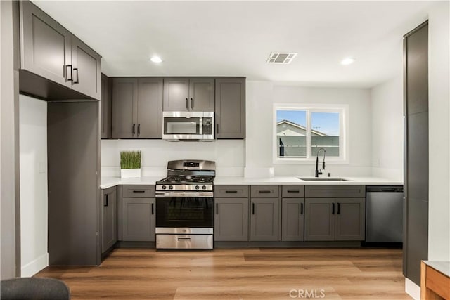 kitchen with stainless steel appliances, visible vents, a sink, and recessed lighting
