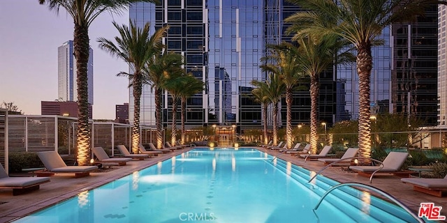 community pool with a patio area