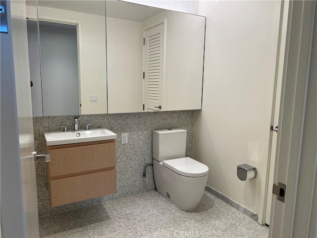 half bath featuring vanity, decorative backsplash, and toilet