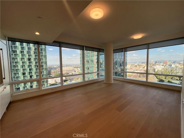 unfurnished sunroom with a view of city and a healthy amount of sunlight