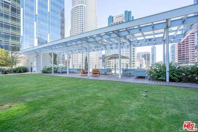 exterior space featuring an outdoor hangout area, a view of city, a pergola, and a yard