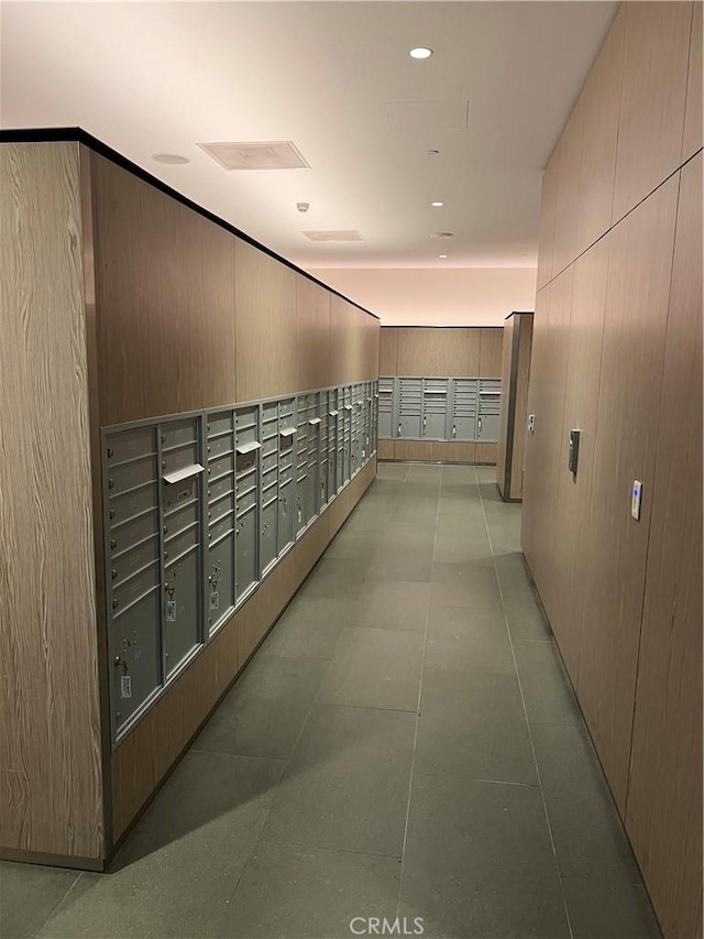corridor with wooden walls and mail area