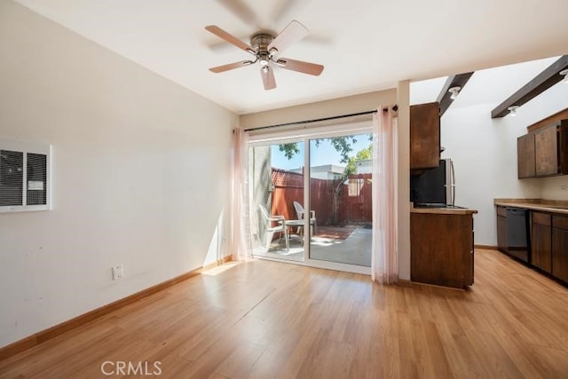 interior space with baseboards, ceiling fan, light wood-type flooring, and visible vents