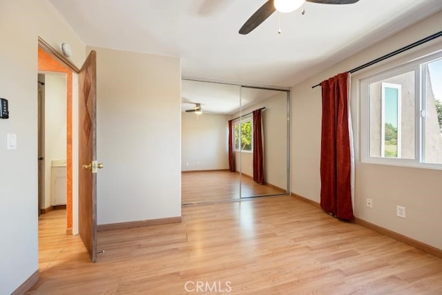 spare room with light wood-style floors, baseboards, and ceiling fan