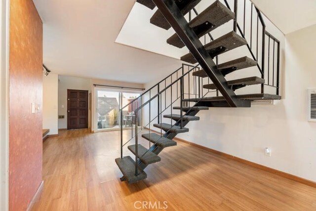 stairs featuring baseboards and wood finished floors